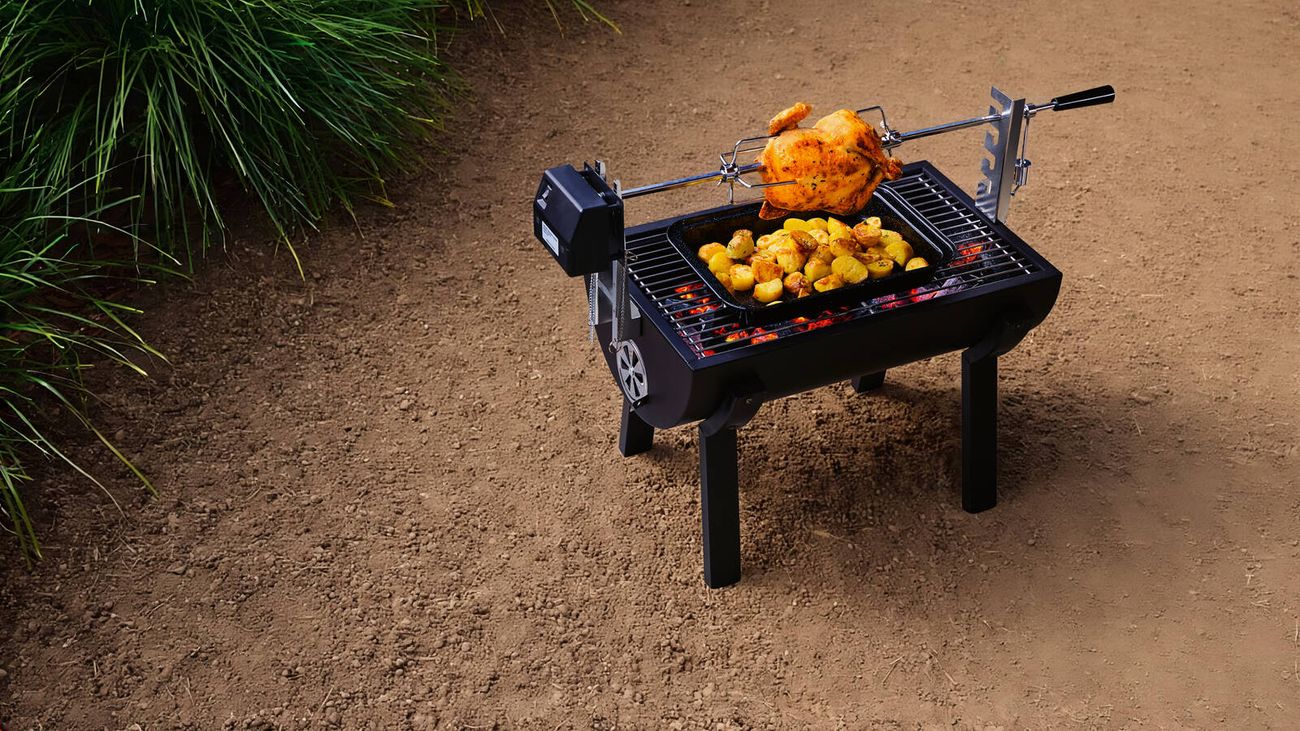 Three men stand around a bbq while food cooks
