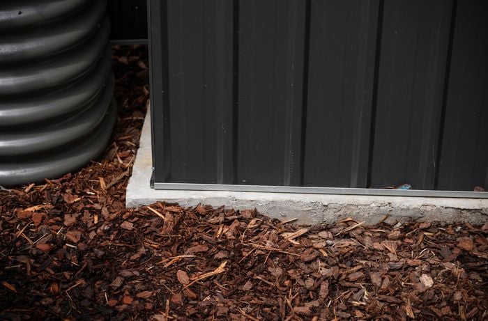 Shed corner on concrete base.