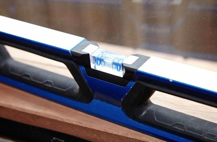 Using the spirit level to check the window is level