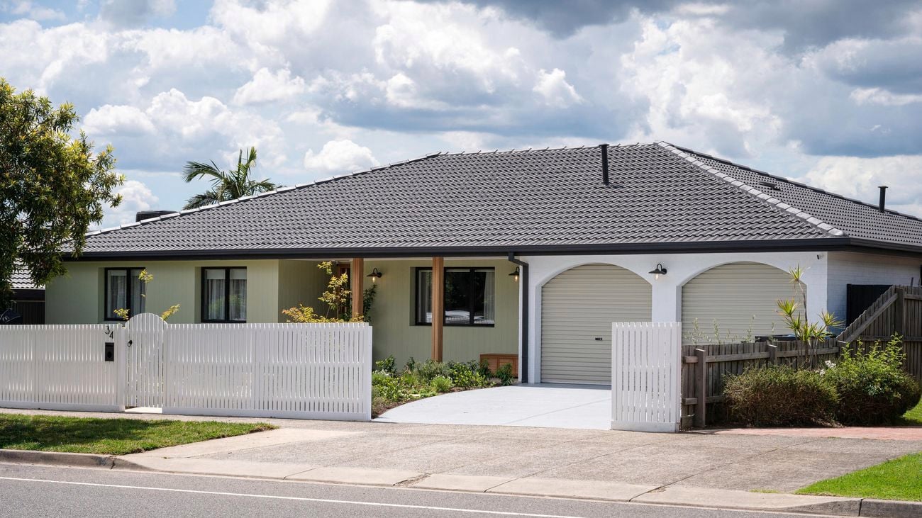 Front of house with a picket fence at the front of it