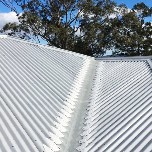 Close up of a roof with an installed gutter mesh.