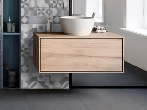 floating vanity in  bathroom with tile walls