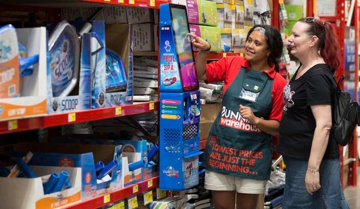 Bunnings team member helping customer in pool section.