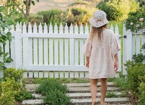 Sleepers interspersed with plantings of fragrant thyme lead the way to the garden gate.