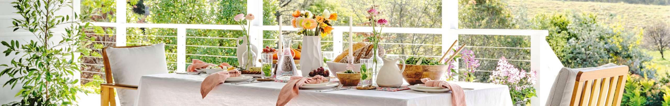 Outdoor table with assorted vases and colourful floors on display