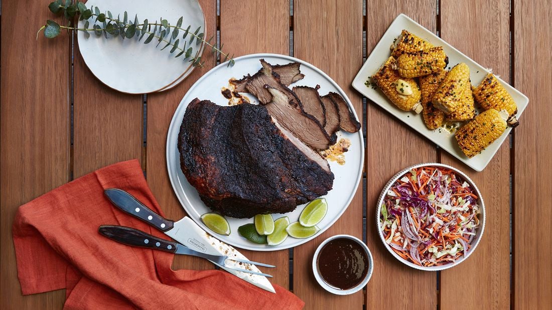 A plate of brisket, served with chilli pickle slaw and grilled corn