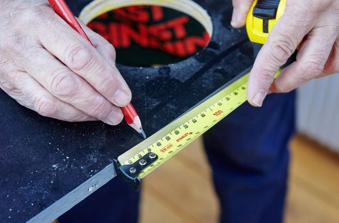 A tape measure being used to mark the vertical garden tier for cutting