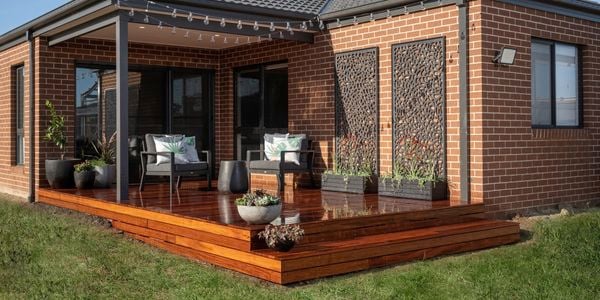 A completed deck attached to a brick house