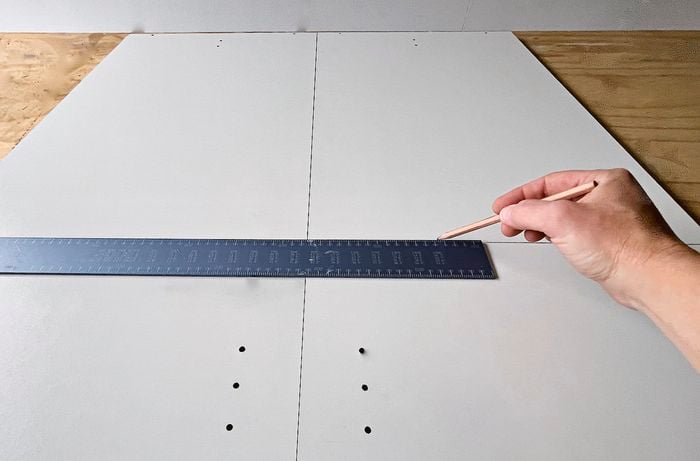  builder’s square and pencil used to measure the side of a cupboard] 