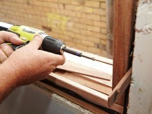Driving the screws into the pilot holes