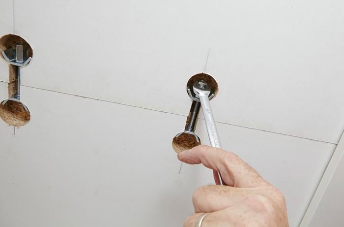 Two pieces of benchtop being secured together from below