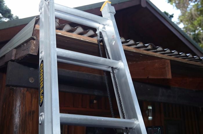 Ladder resting against a corrugated metal roof