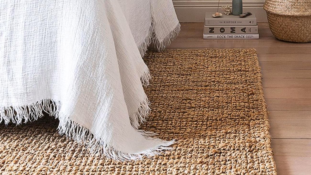 Bed on top of rug.