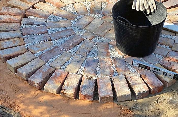 A partially completed brick paved patio