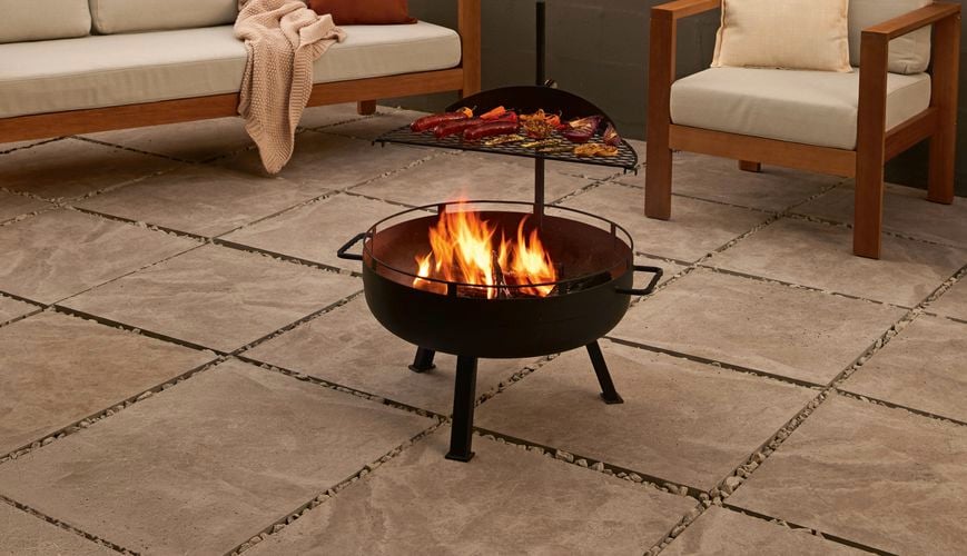 A fire pit and an outdoor setting in an outdoor entertaining area.