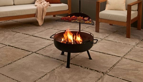 A fire pit and an outdoor setting in an outdoor entertaining area.