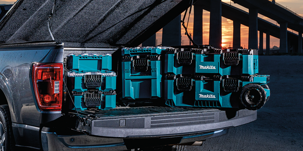 Maktrak storage in a truck under a bridge.