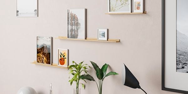 Various wall prints on the wall and also located on some photo shelves.