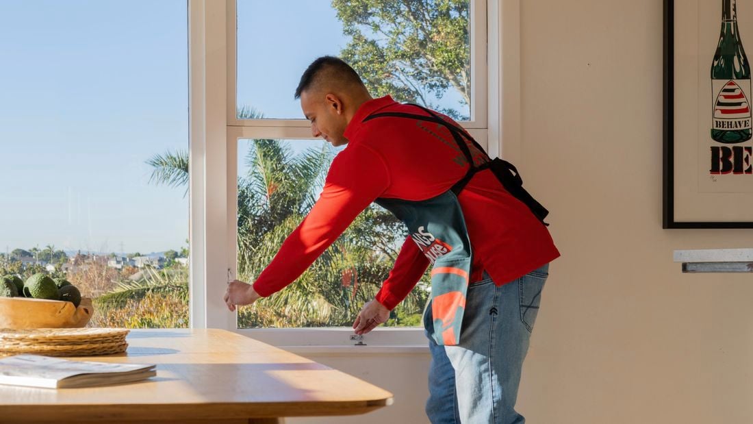 A person opening up a window.