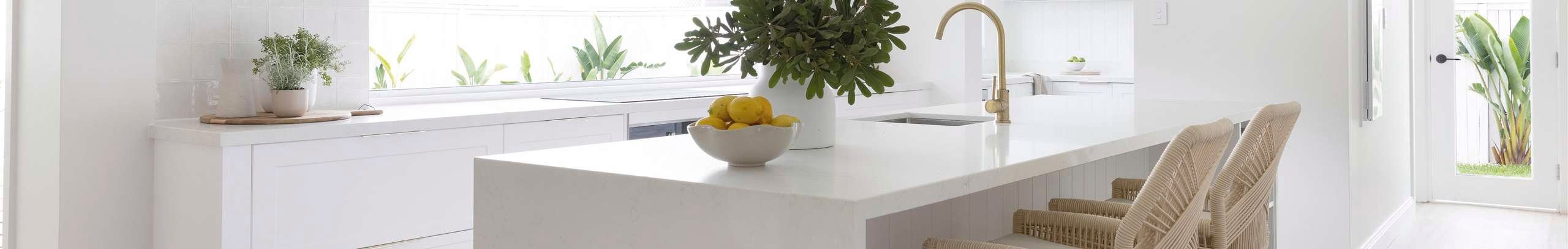 White stone top kitchen with wicker bar stools 