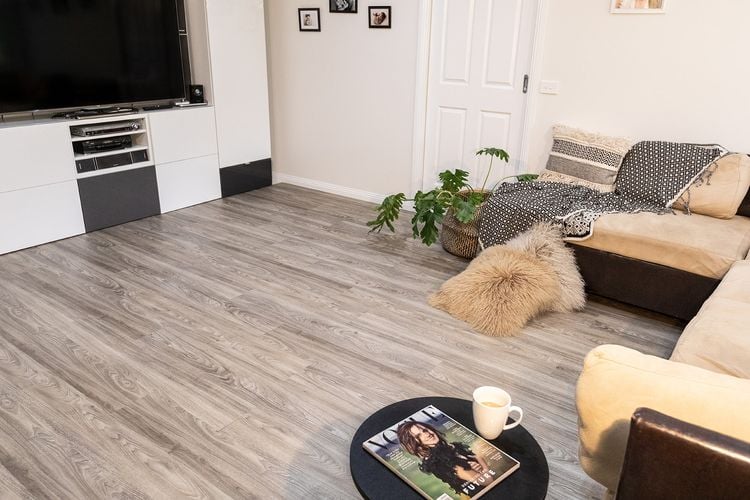 Living room with sofa and vinyl plank timber-look floor