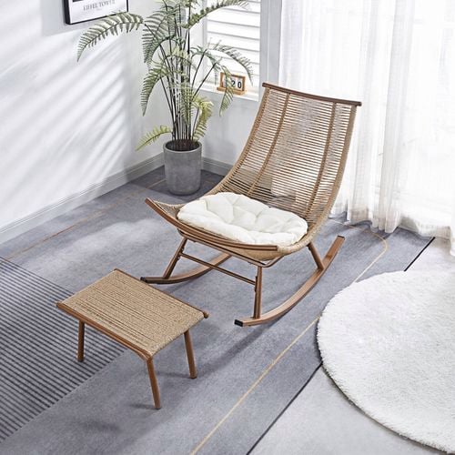 This curved rattan rocking chair features a sculpted wood frame and plush cushion for effortless relaxation.