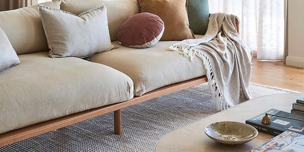 Lounge room with table, couch, carpet and curtains