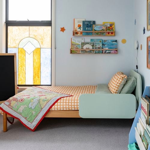 Kids bedroom with books on a floating bookshelf