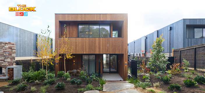 Modern two-storey home featuring timber cladding, large windows, a landscaped front garden and a natural stone pathway.