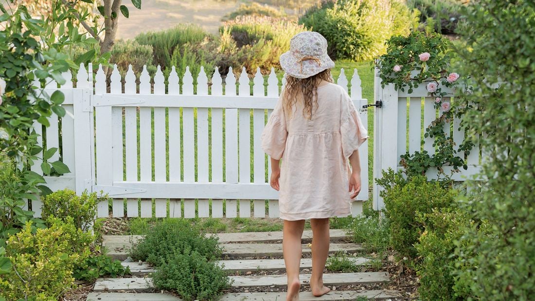Sleepers interspersed with plantings of fragrant thyme lead the way to the garden gate.