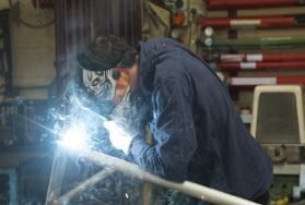 Person welding while wearing mask