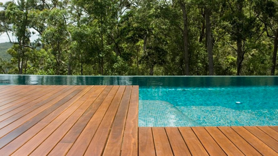 Timber deck on side of swimming pool.