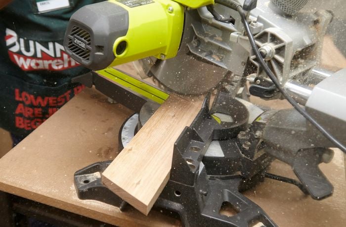 Person using circular saw to cut piece of ply wood to size.
