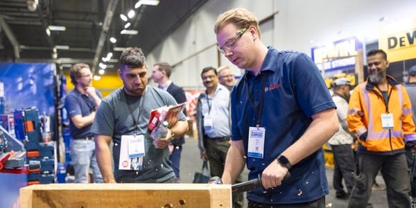 trade customers watching a tool demonstration at the Bunnings trade expo, in NZ