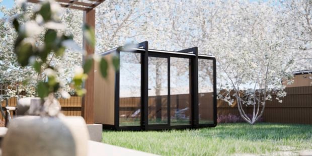 A room outside with trees and a fence around it.