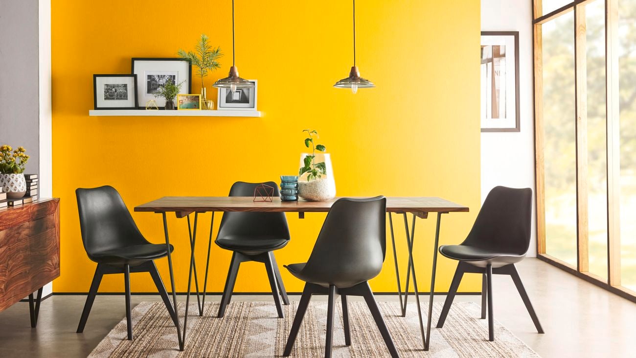 A feature wall in a dining room painted in Taubmans Gone Bananas.