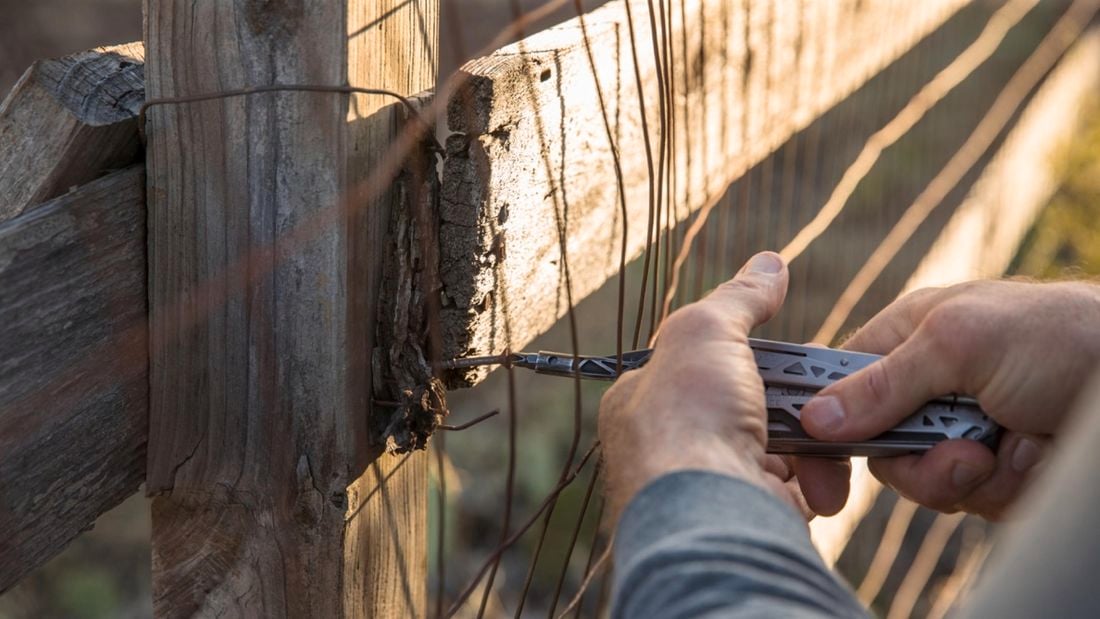 Person using a Gerber Dual-Force  tool to fix a wire fence