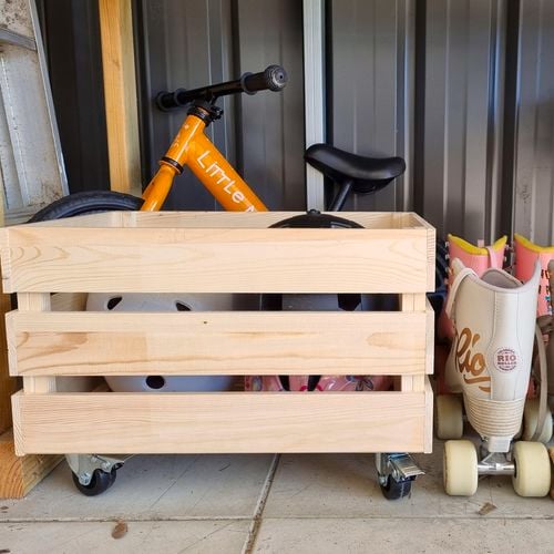 Timber crate with wheels with stored helmets inside.