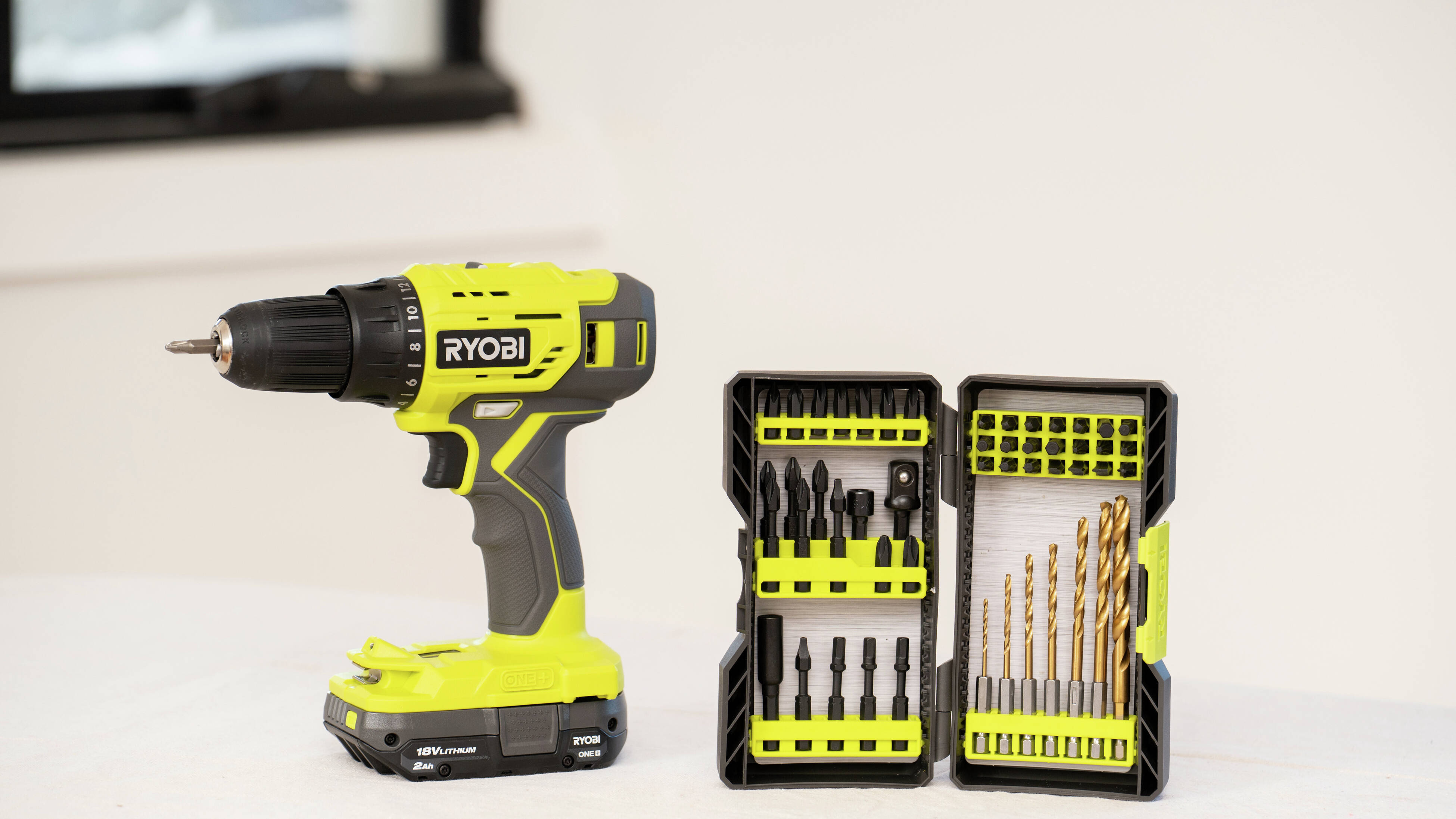 A drill driver is shown with a complete drill and driver bit set, making it easy to switch between drilling and screwdriving for furniture assembly and home maintenance.