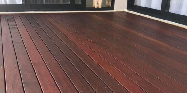 A decking which connects to glass sliding doors.
