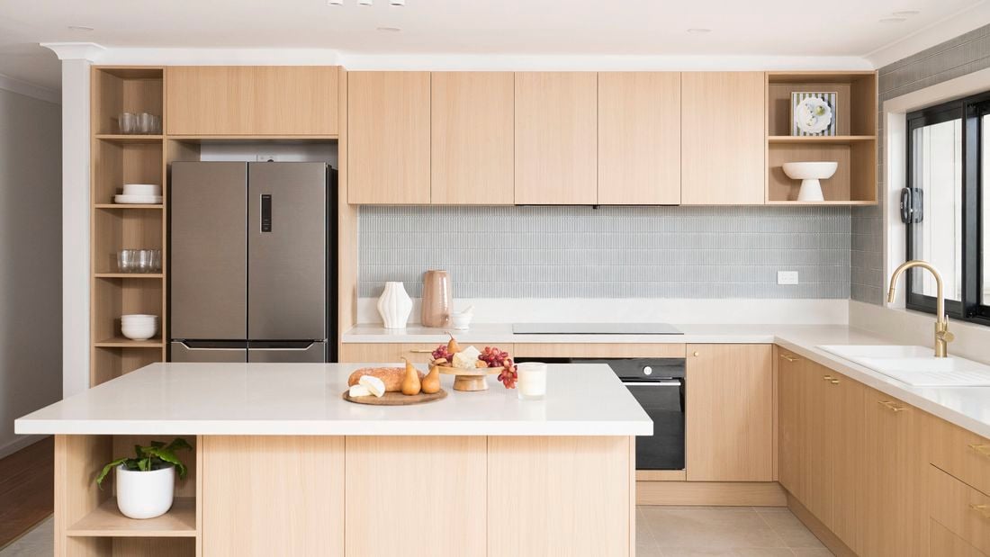  Natural Neutrals tone kitchen with brass fixtures, grey tile splashback, and a clean white island 