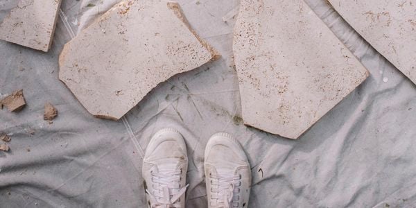 Broken tile pieces arranged on dropsheet