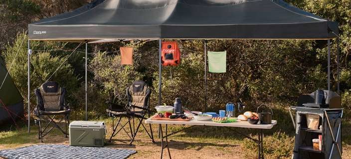 Camping set up with gazebo and camping accessories.