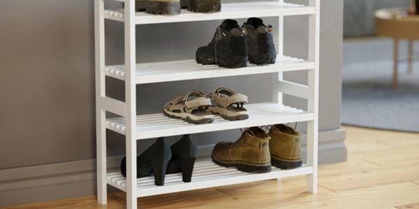 Shoe rack in hallway with shoes placed in 