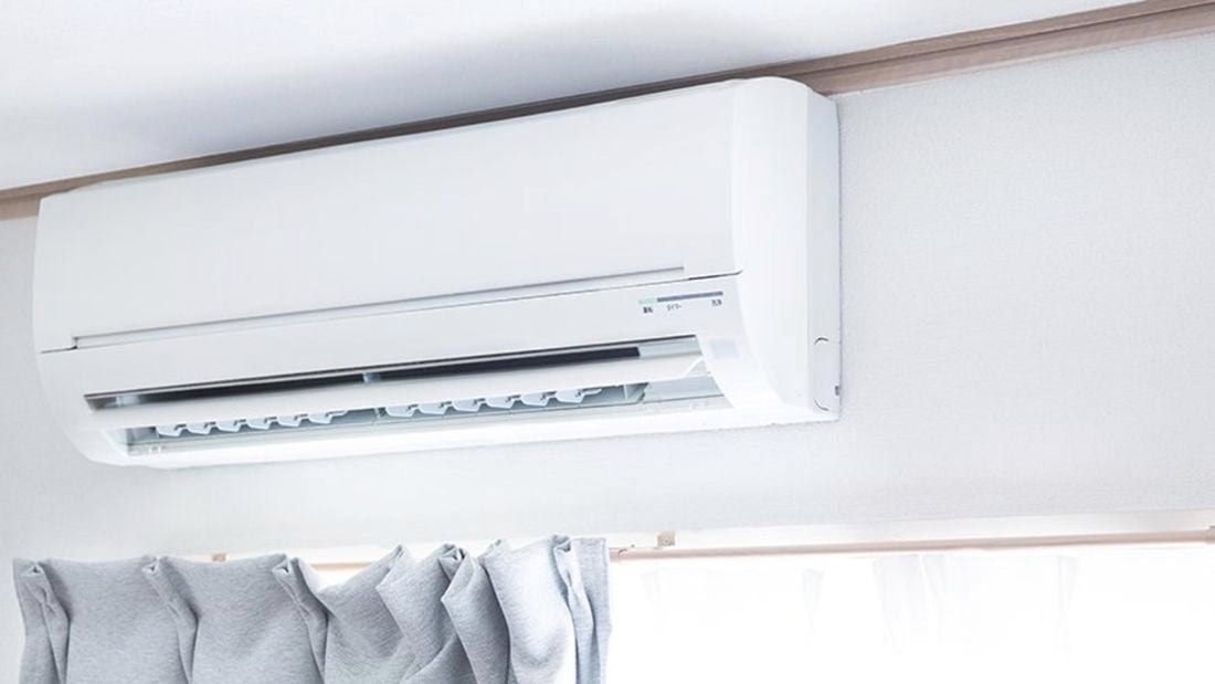 Split system air conditioner installed above the curtains.